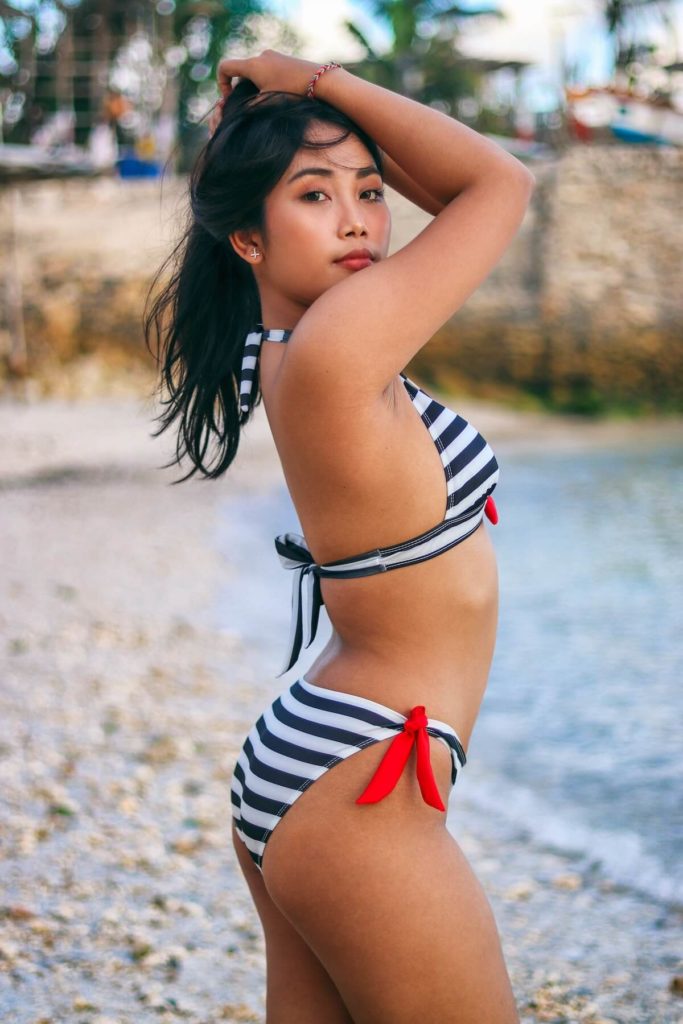 Sexy Filipina woman at the beach in bikini